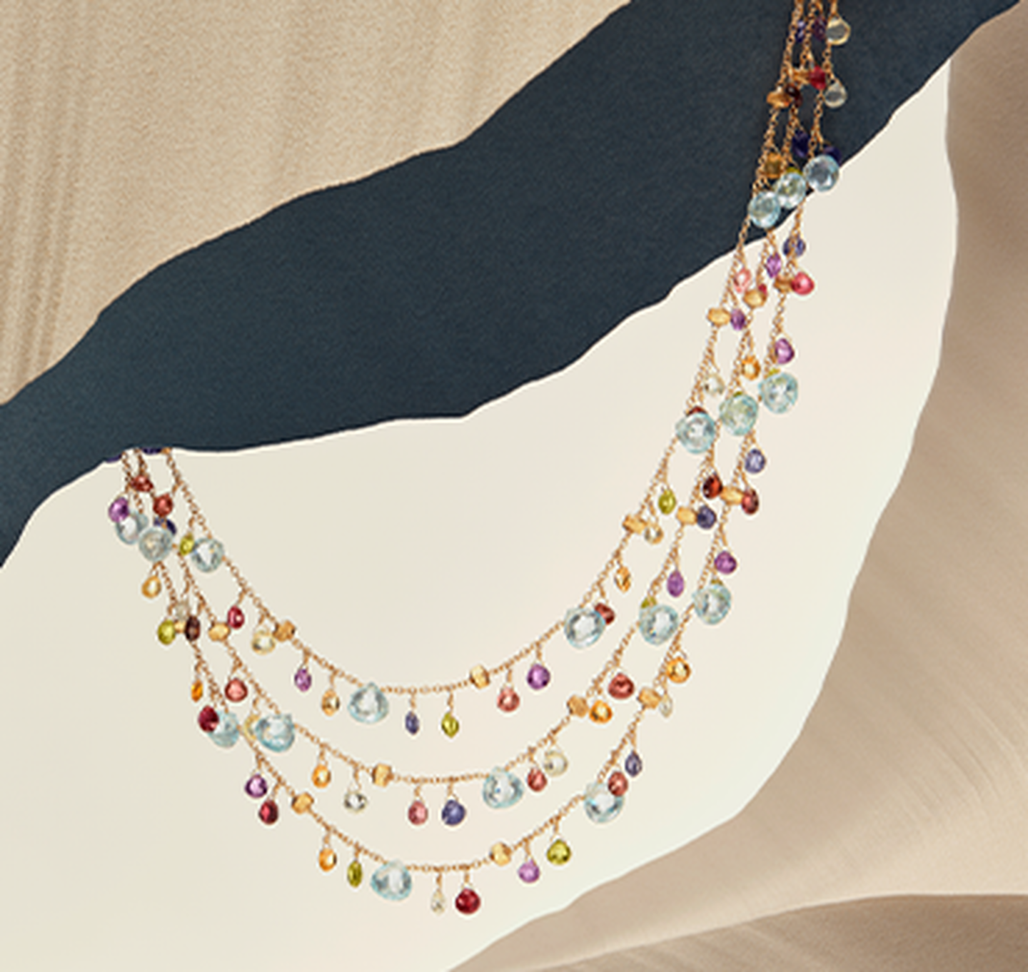 Paradise necklaces resting on a sandy background.